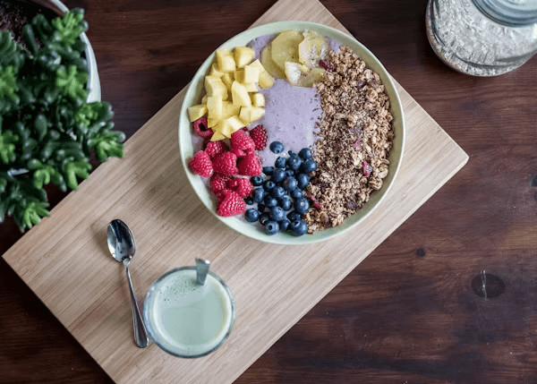 Bowl of fruit and yogurt with glass of milk for gut health