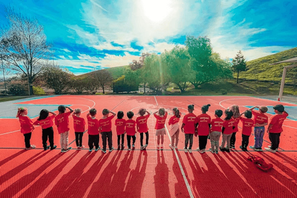 People gathered on outdoor basketball court