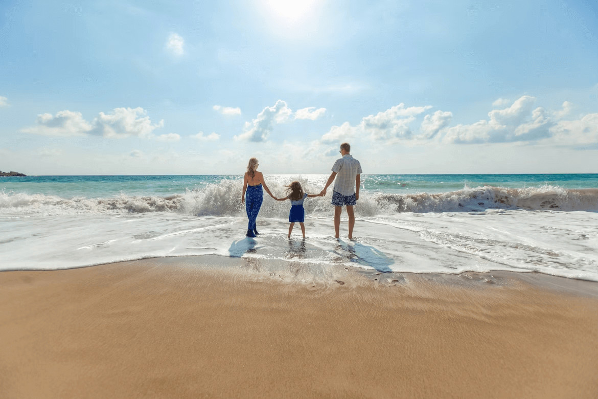 Couple holding hands walking on Italian beach