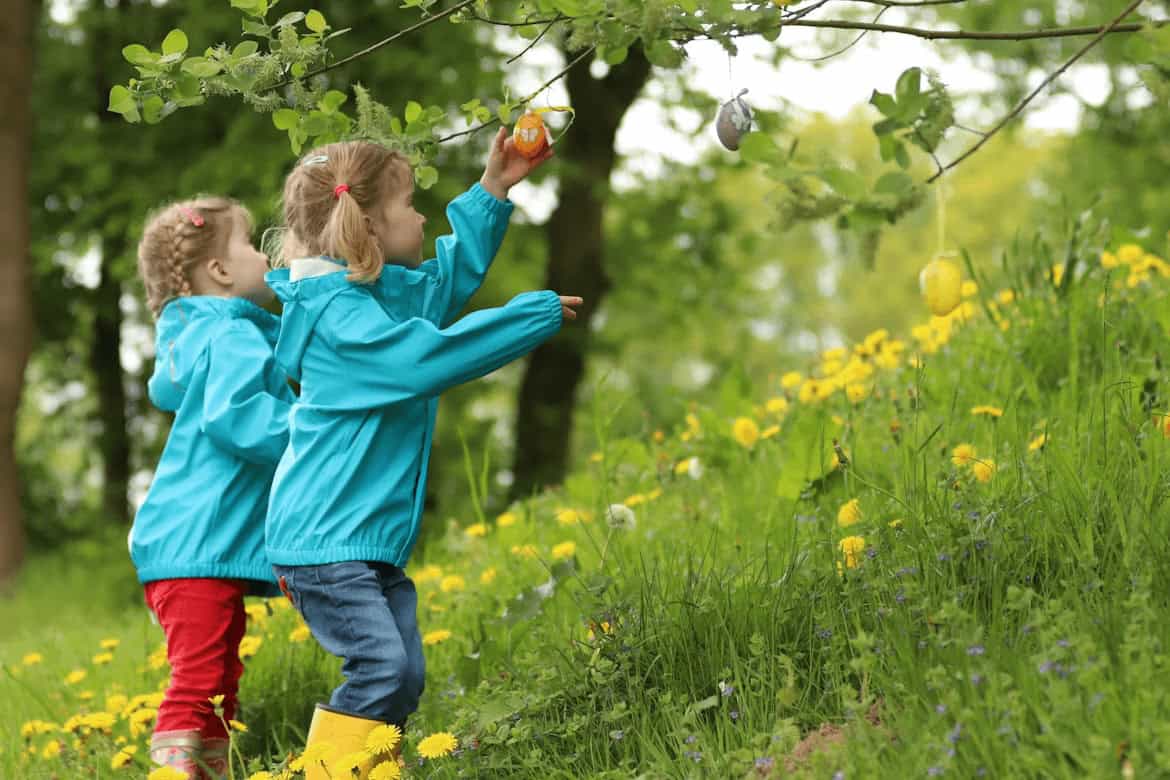 Two young girls playing on grass outdoors