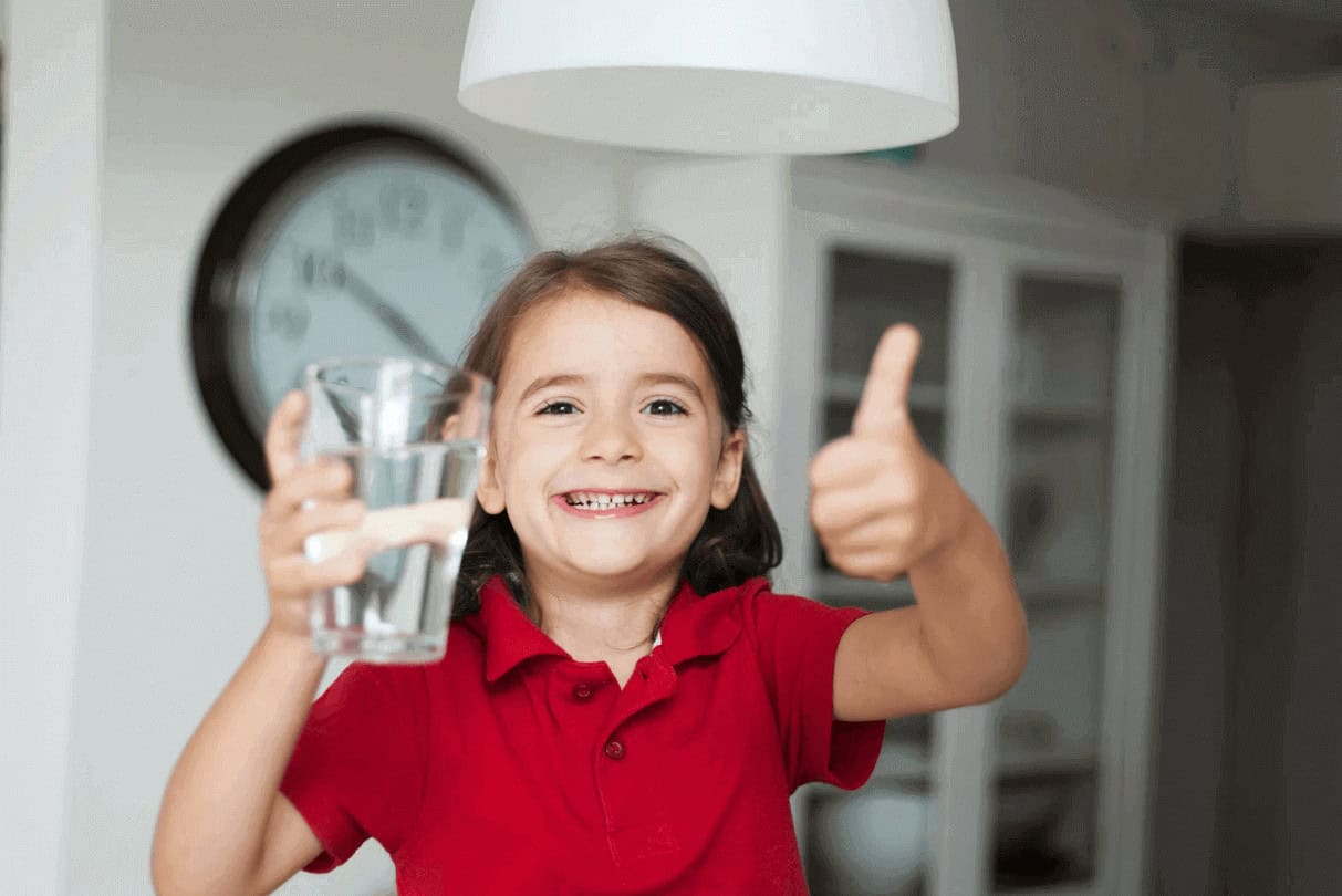 Young girl drinking water for hydration