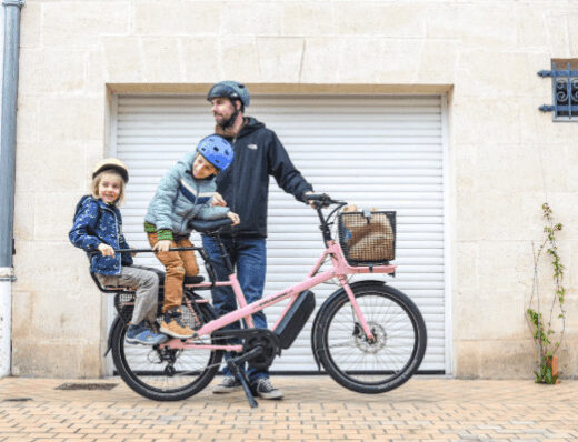 dad with kids riding a bike
