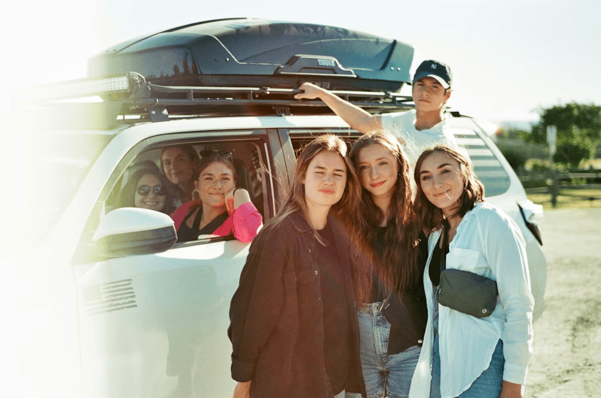 Family stands in front of their camper