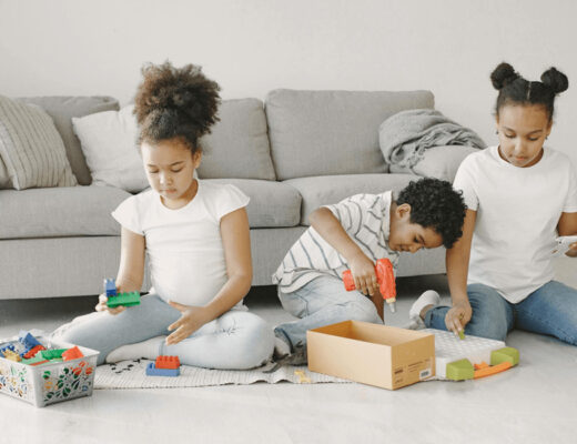 Happy children playing with toys on floor