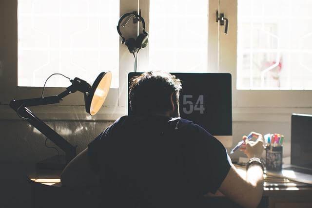 Man working efficiently at a home desk with a