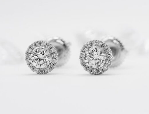 A pair of diamond stud earrings on a