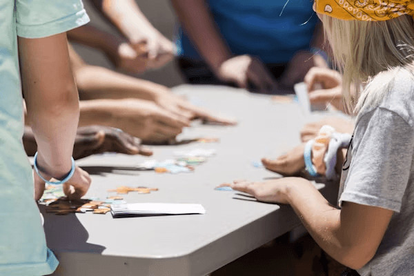 Family playing a homemade game around a table