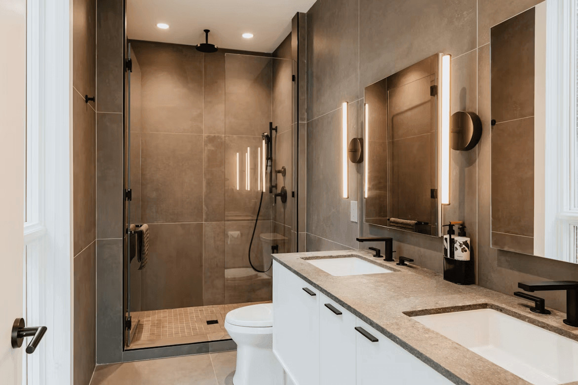 Modern bathroom with two sinks and a walk-in