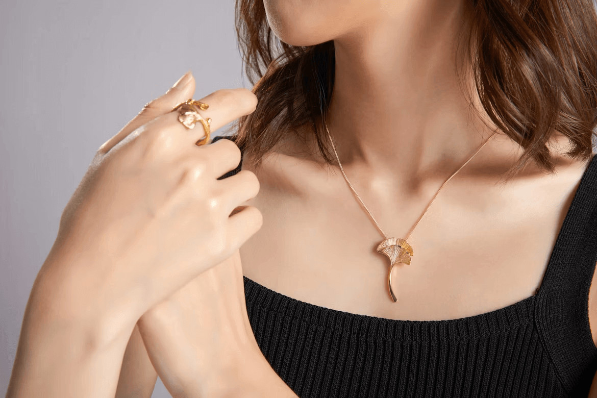 Woman in black top wearing a gold