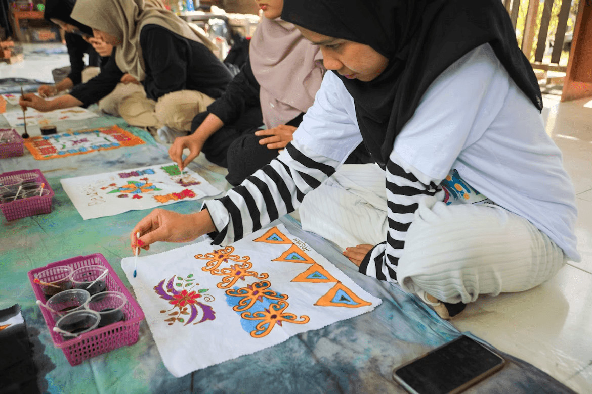 Family painting together on a table