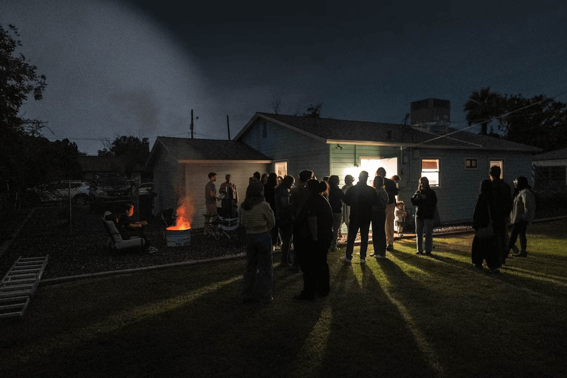 Guests celebrating outside a house at night