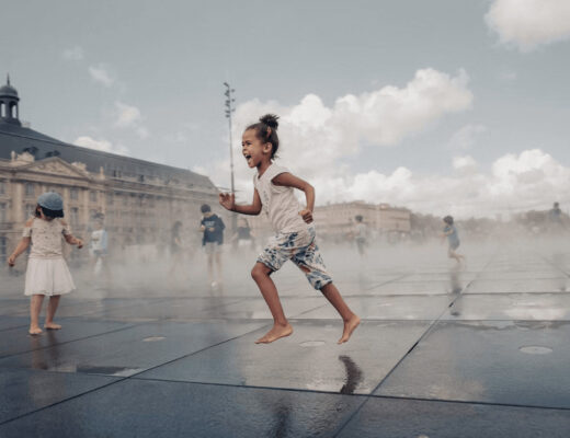 Little girl with an umbrella joyfully running in