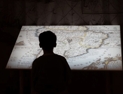 Man interacting with a projected map in an educational exhibition