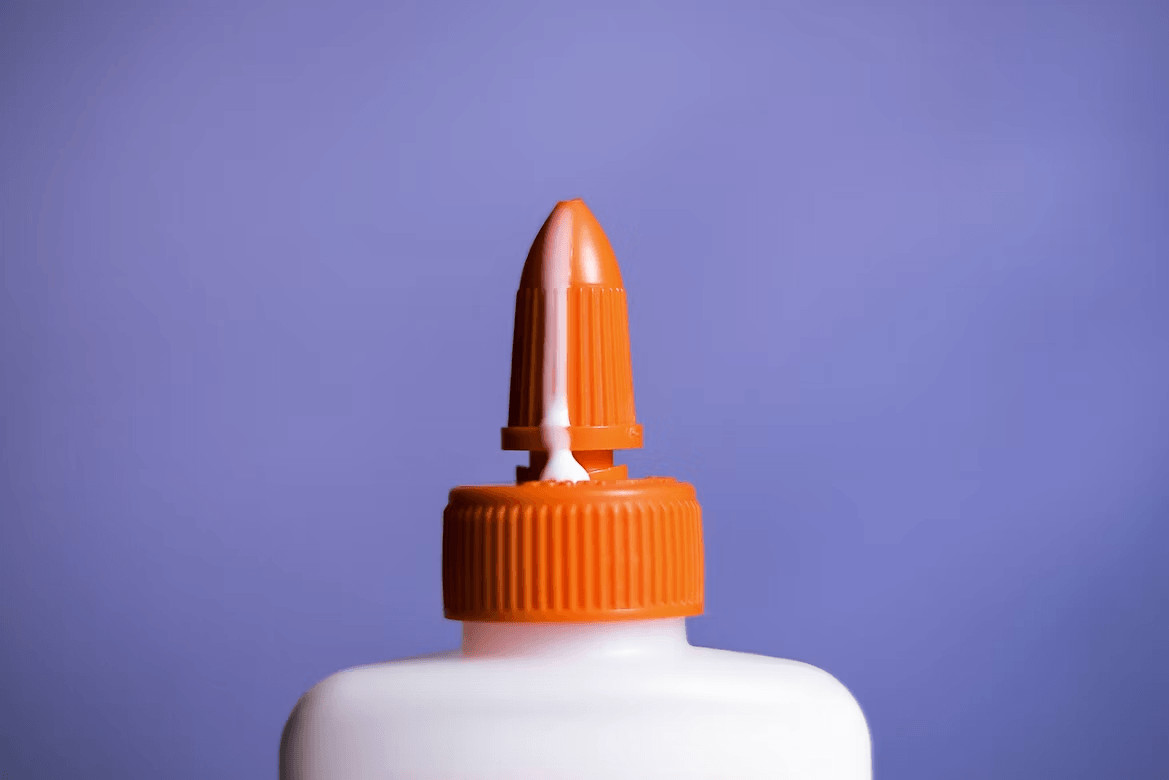 Orange and white liquid glue bottle for card