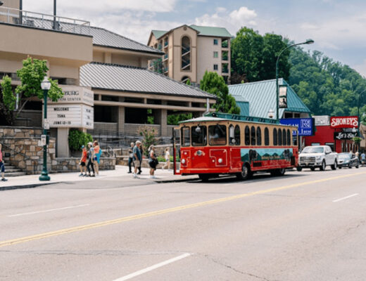 Red trolley car traveling through Gatlinburg