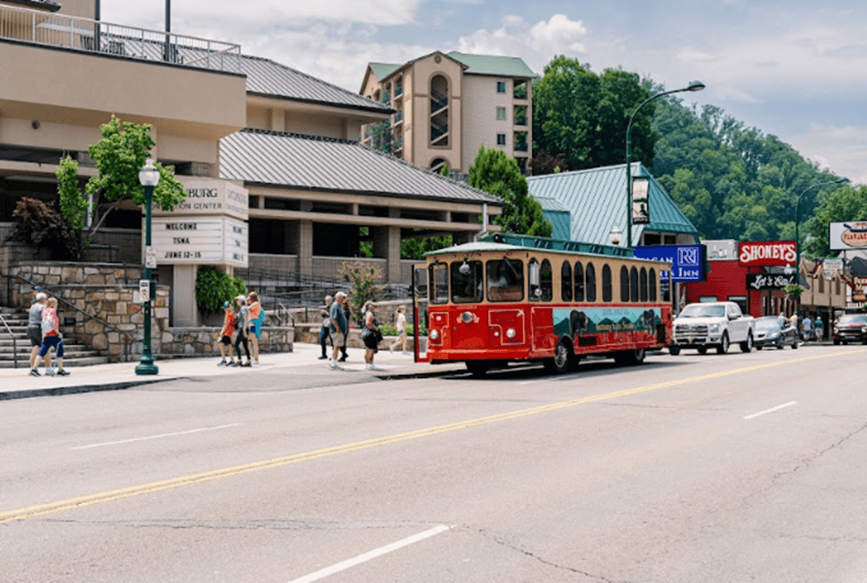 Red trolley car traveling through Gatlinburg