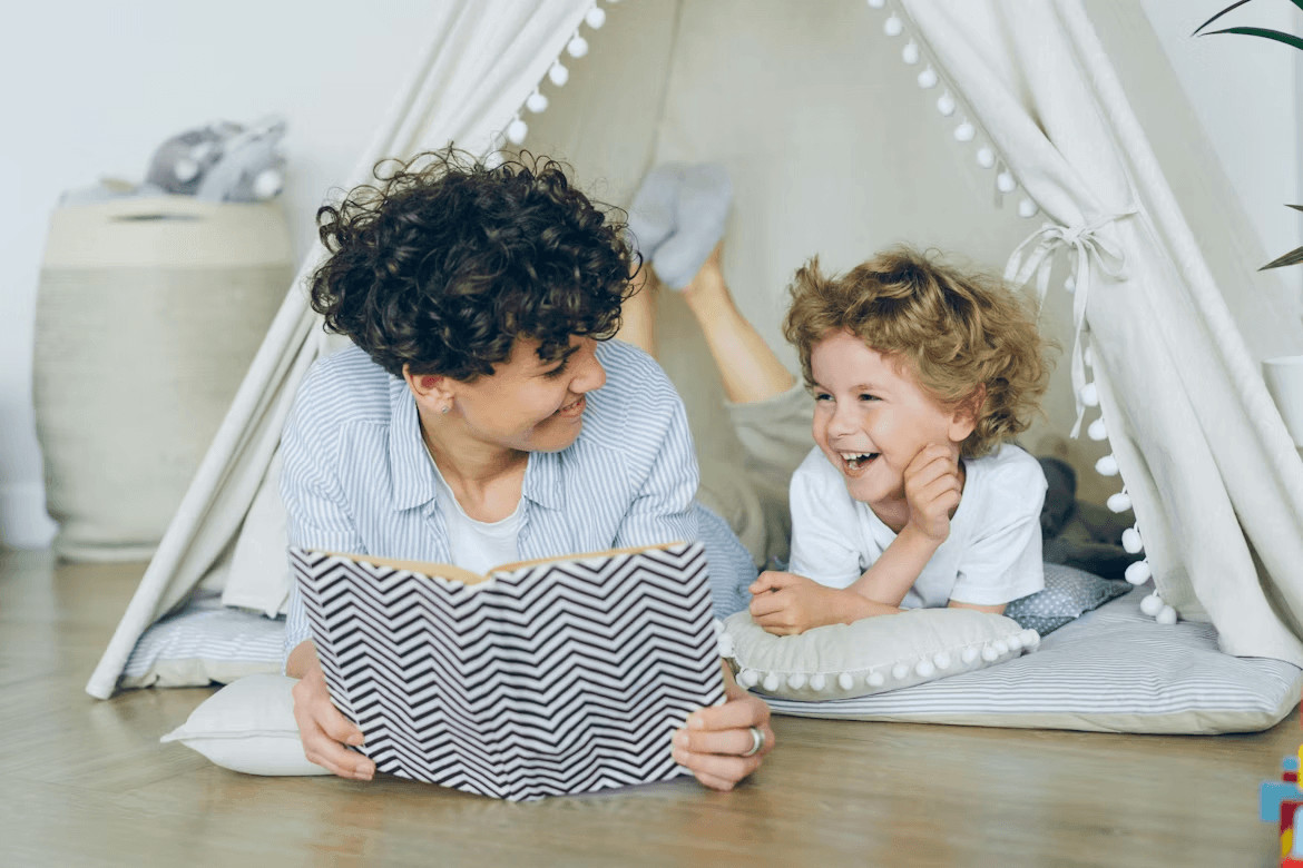 Woman reading a book with a child