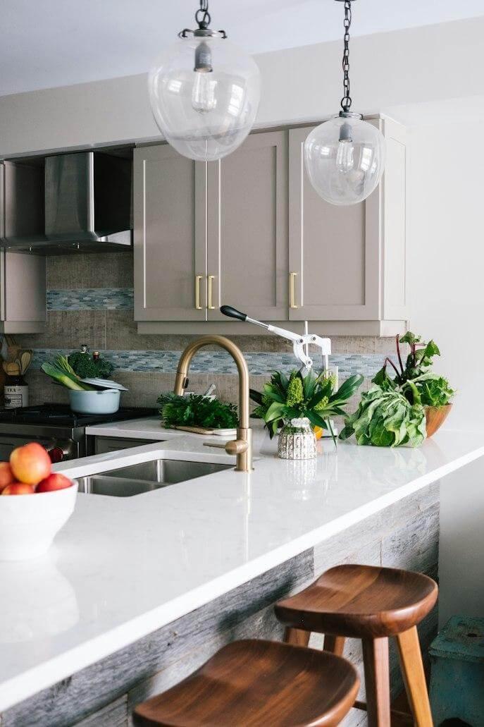 A kitchen with a marble countertop and wooden