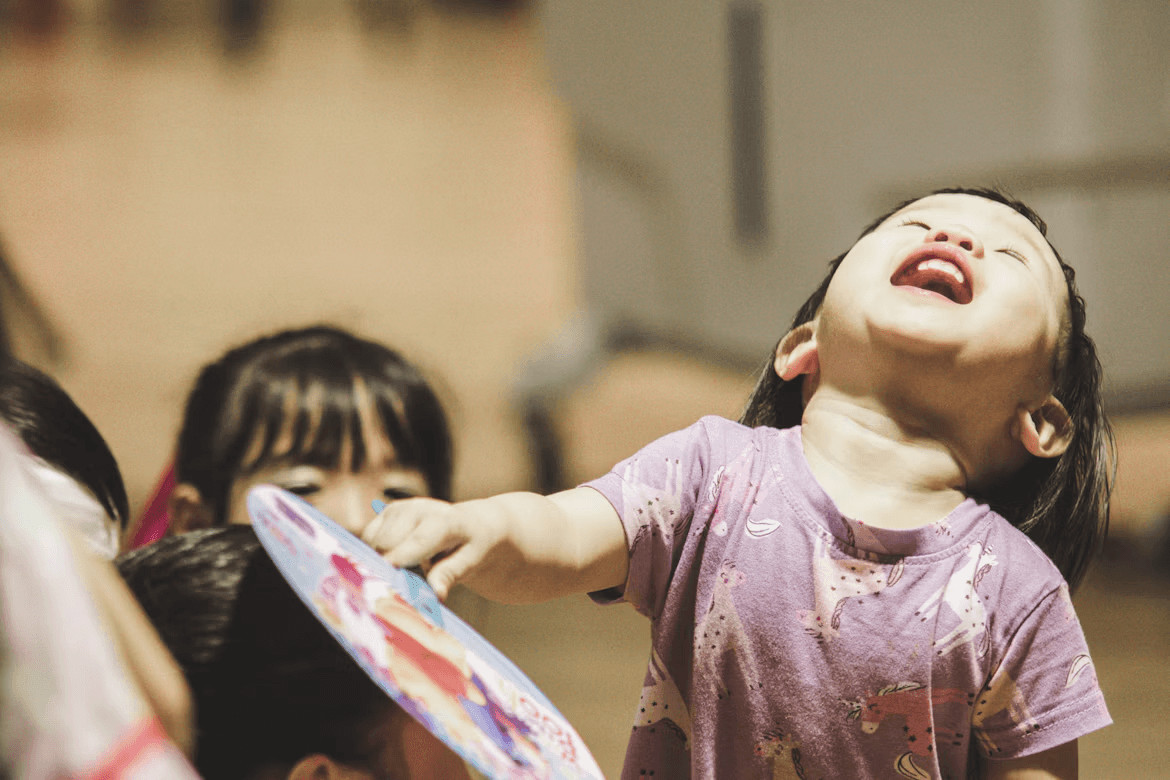 Little girl holding a frisbee
