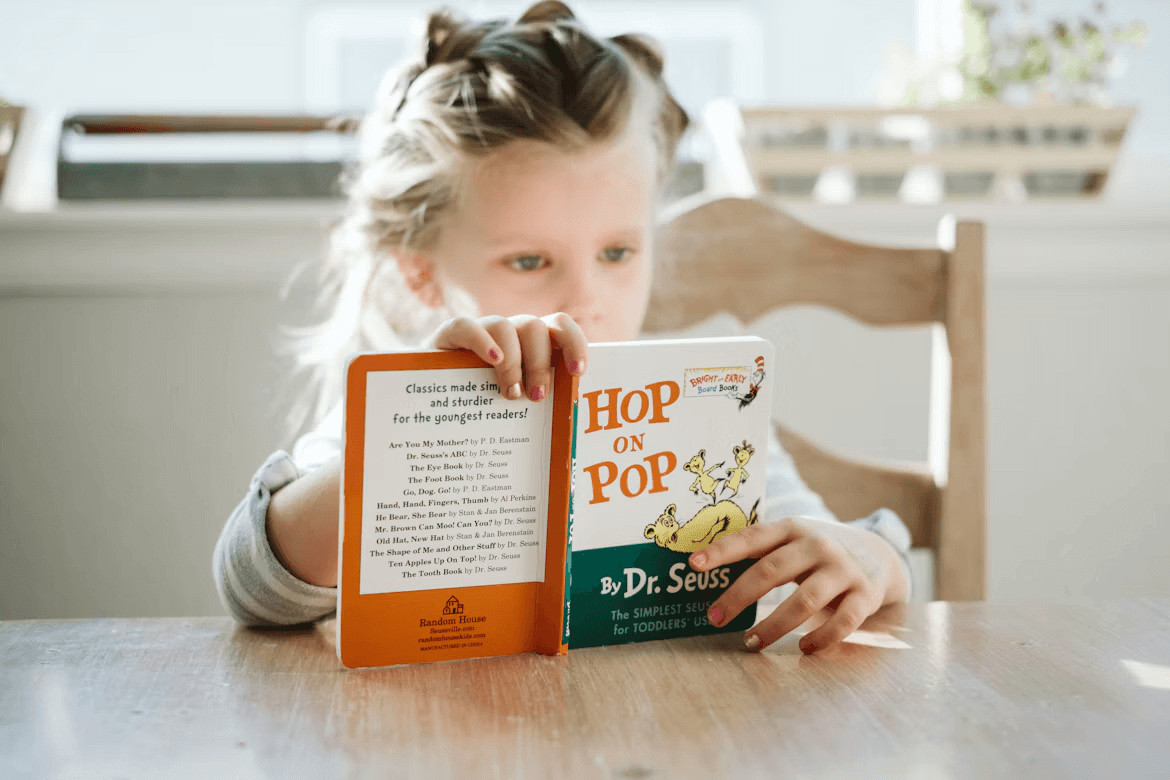 Little girl reading a book in a stylish